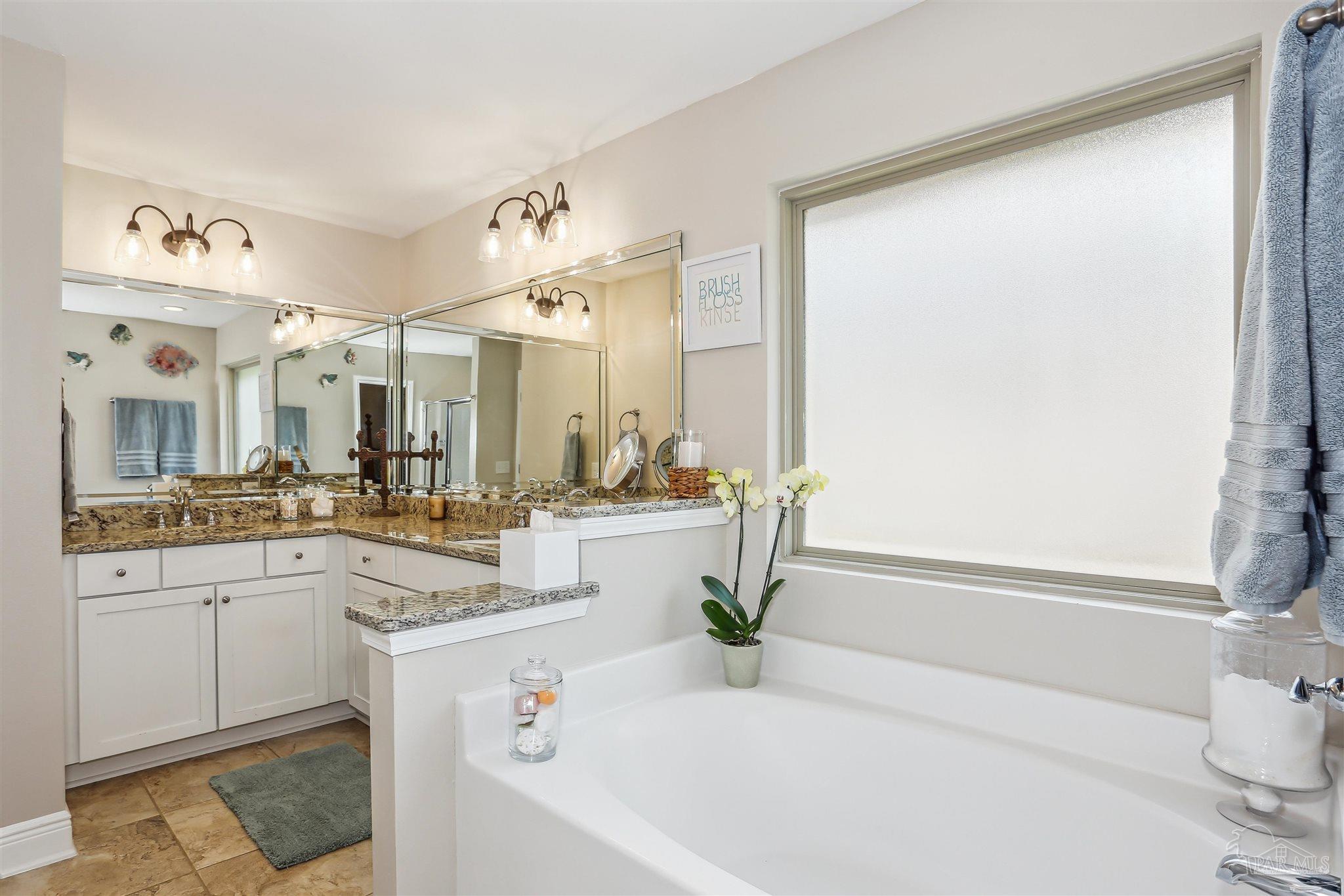 7305 Farmers Road Pensacola, FL 32526 - Photo 20 of 47 a bathroom with a granite countertop sink and a bathtub