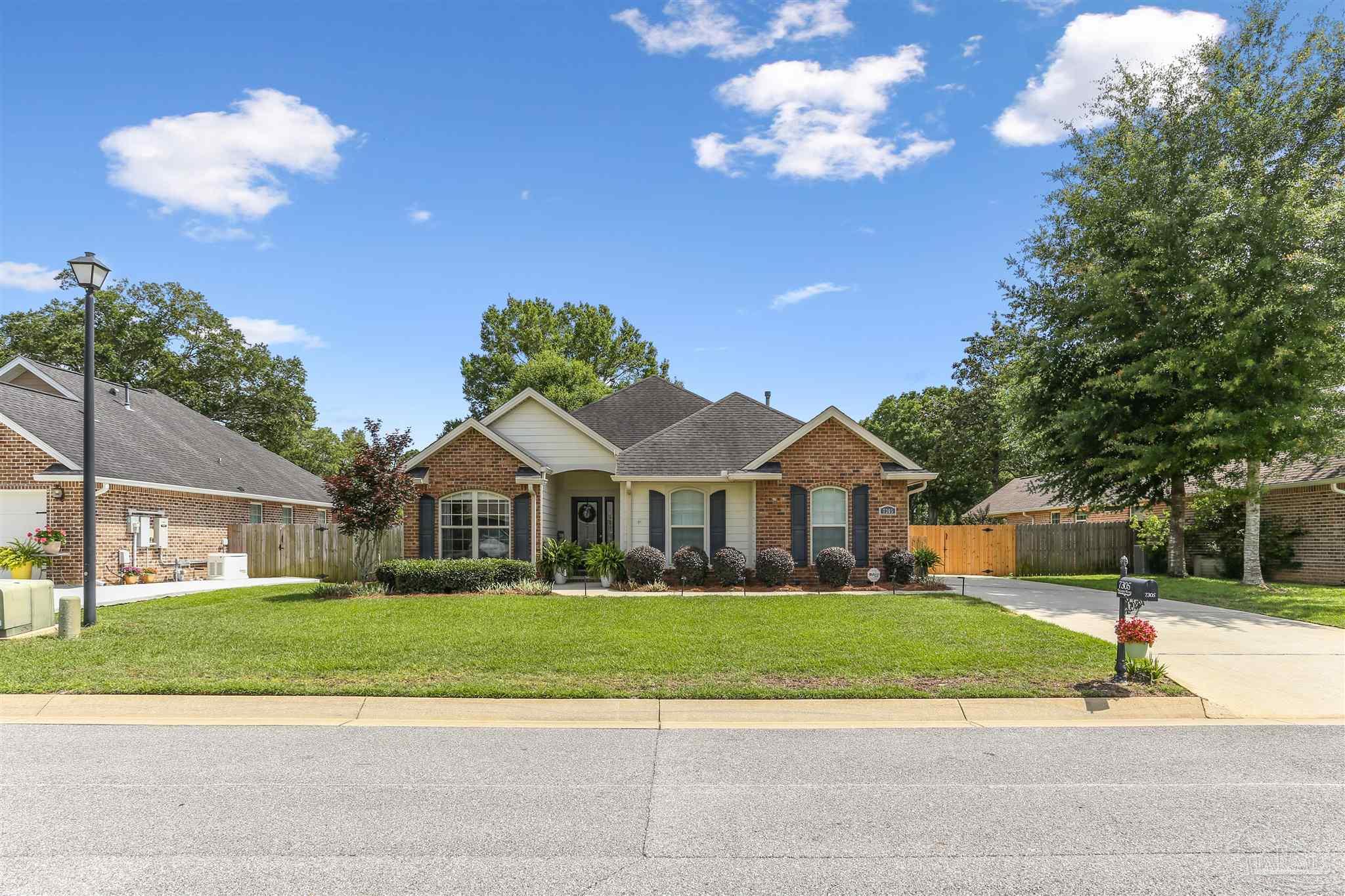 7305 Farmers Road Pensacola, FL 32526 - Photo 2 of 47 a front view of a house with a yard