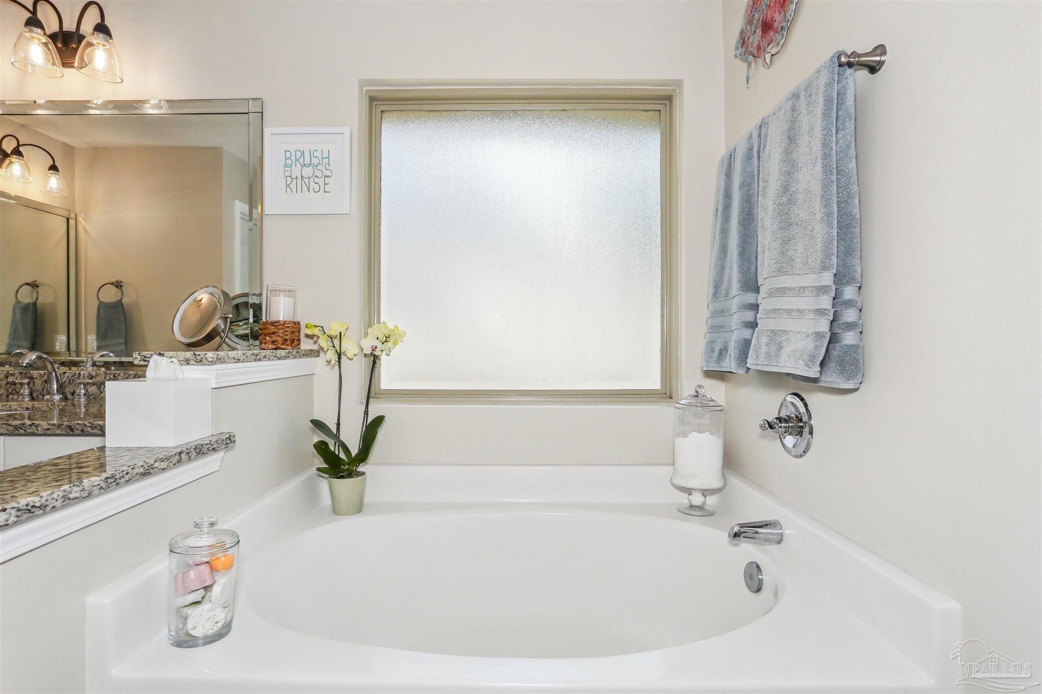 7305 Farmers Road Pensacola, FL 32526 - Photo 23 of 47 a bathroom with a tub sink and mirror