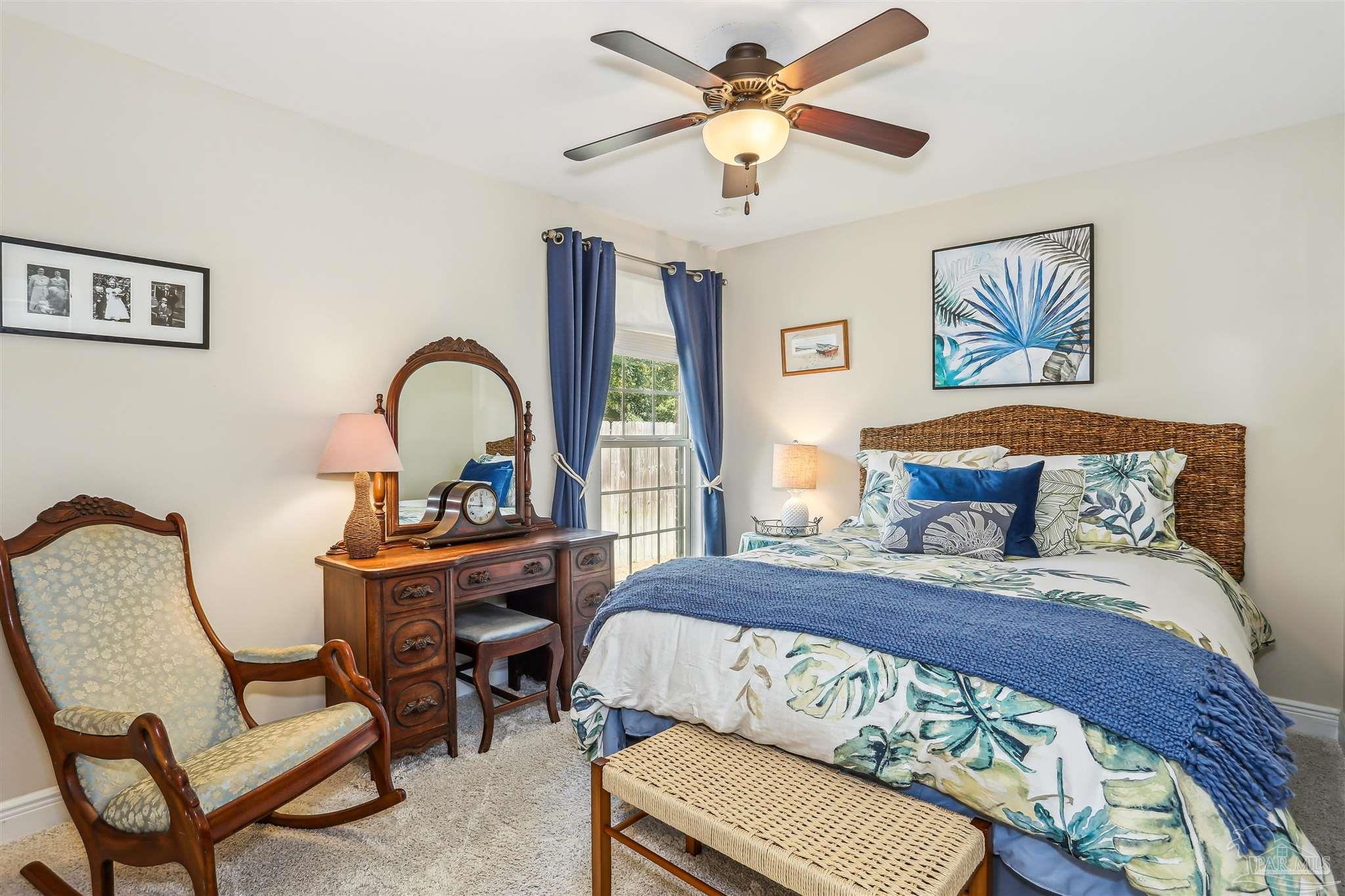 7305 Farmers Road Pensacola, FL 32526 - Photo 26 of 47 a bedroom with a bed and a chandelier