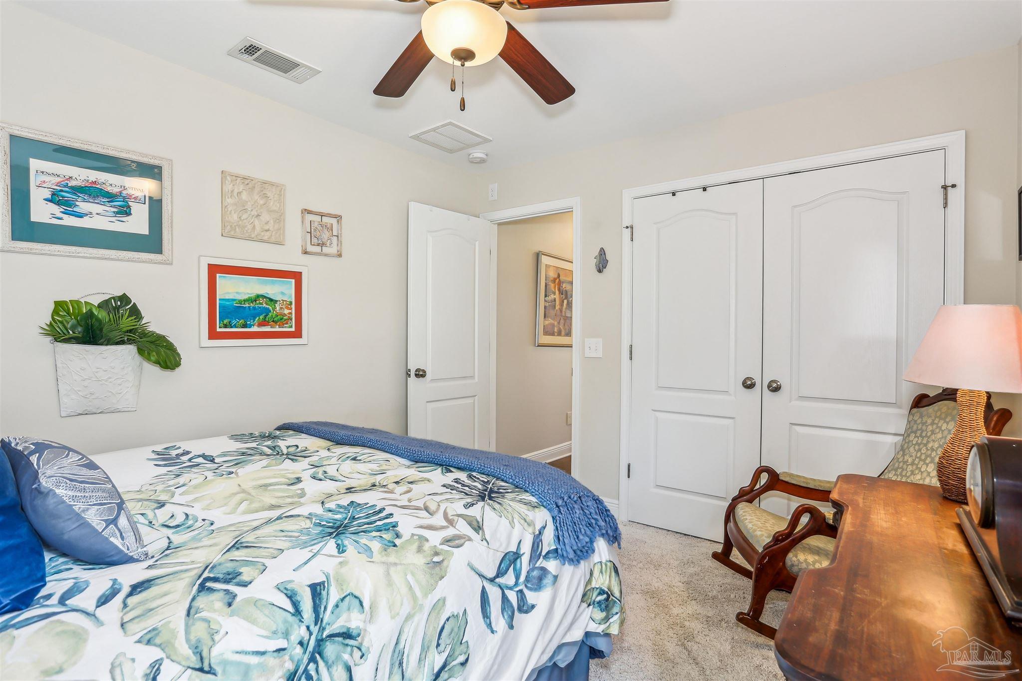 7305 Farmers Road Pensacola, FL 32526 - Photo 27 of 47 a bedroom with a bed and ceiling fan