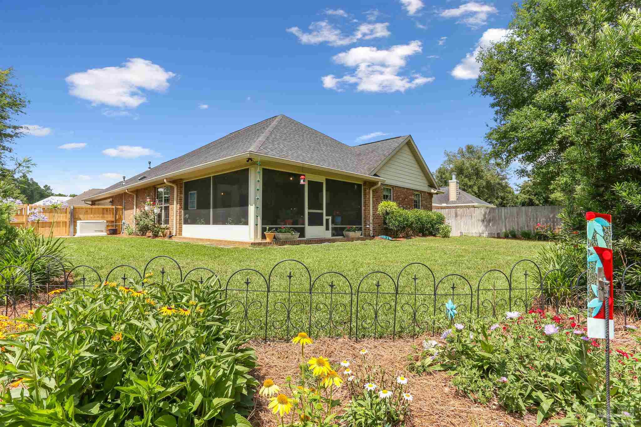 7305 Farmers Road Pensacola, FL 32526 - Photo 34 of 47 a front view of a house with garden
