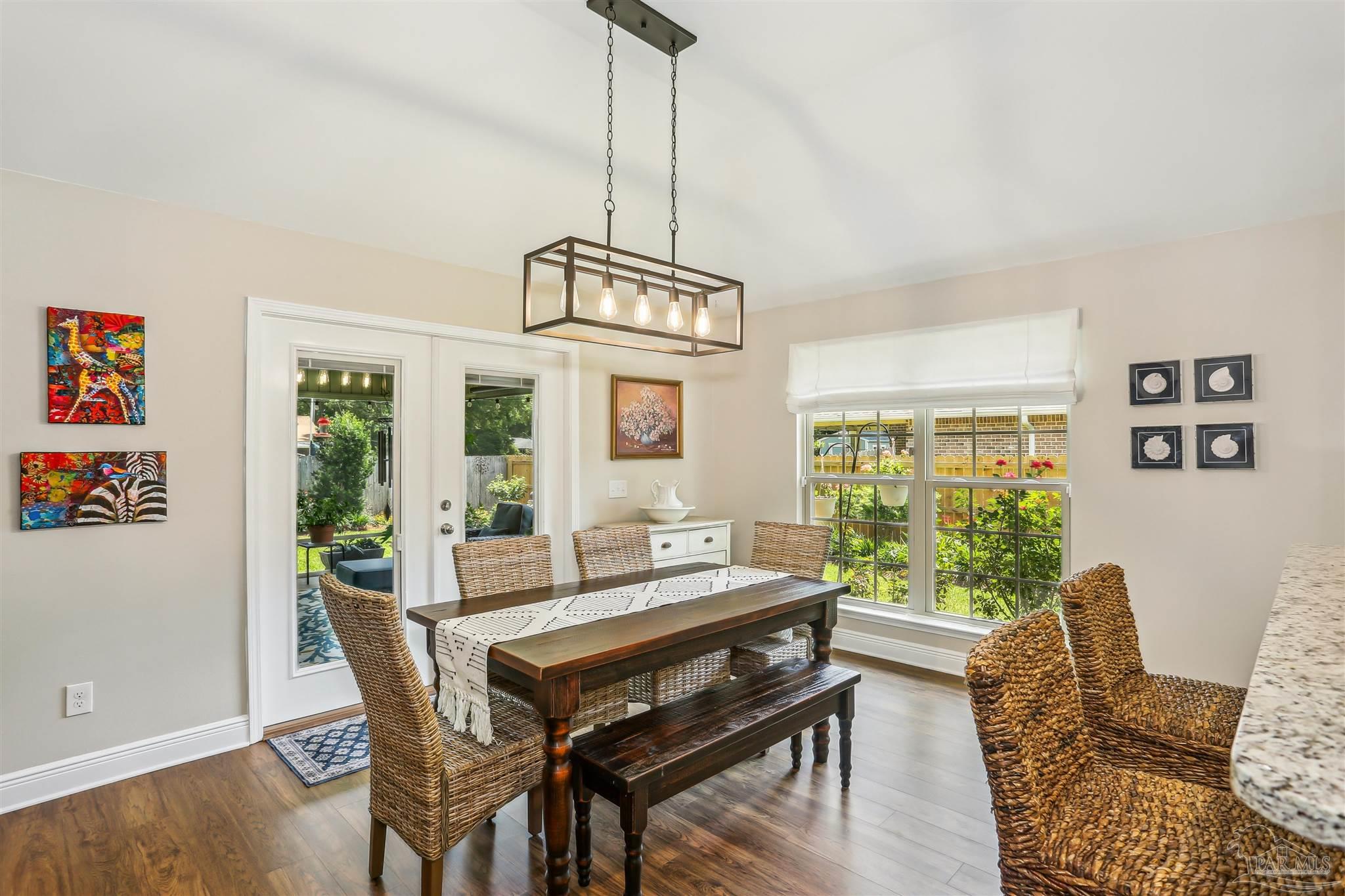 7305 Farmers Road Pensacola, FL 32526 - Photo 10 of 47 a dining room with furniture a chandelier and wooden floor