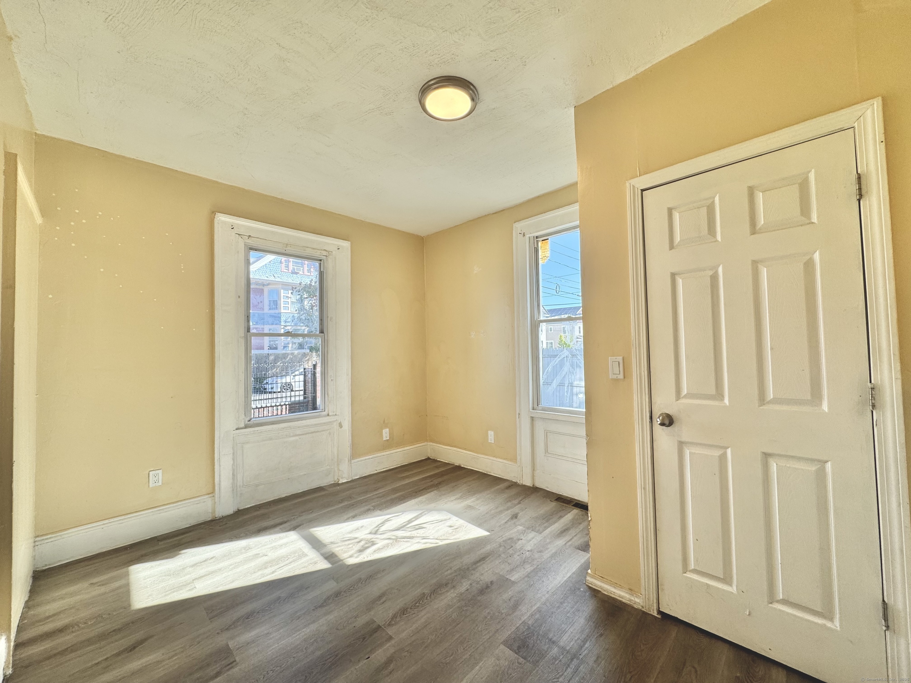 Undisclosed Address Bridgeport, CT 06608 - Photo 12 of 18 an empty room with wooden floor and windows