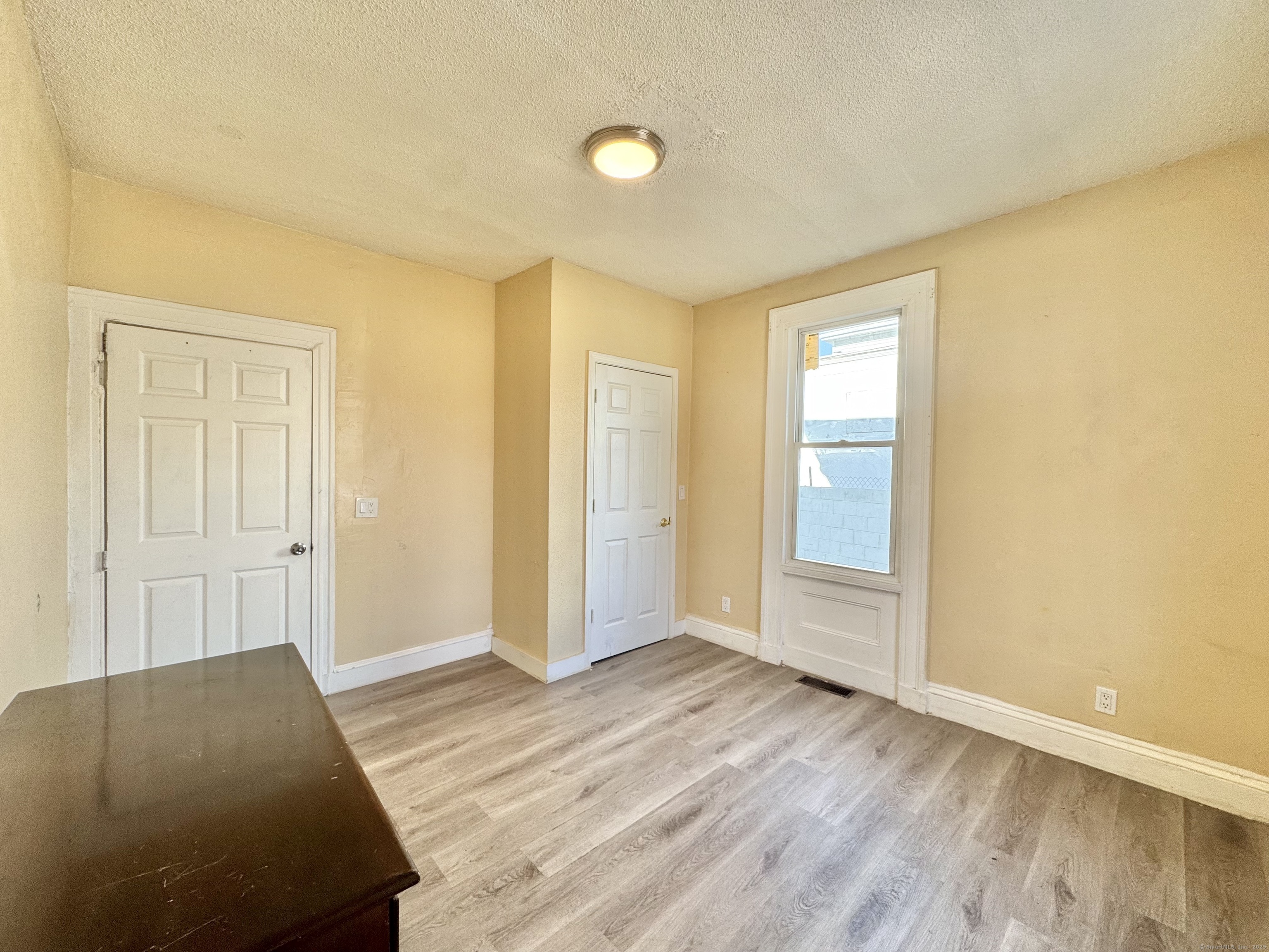 Undisclosed Address Bridgeport, CT 06608 - Photo 13 of 18 a view of a room with wooden floor and bathroom