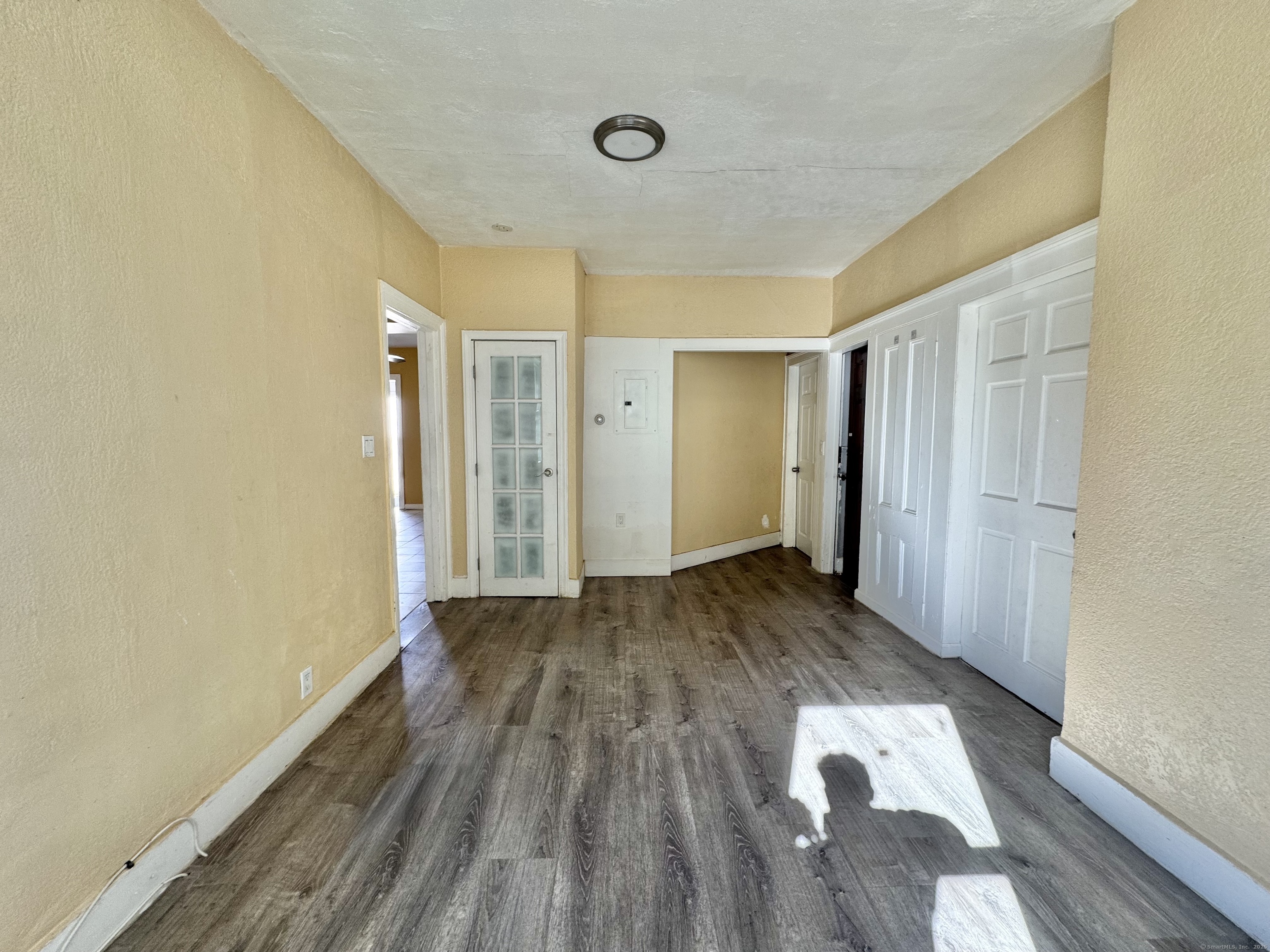 Undisclosed Address Bridgeport, CT 06608 - Photo 4 of 18 a view of a big room with wooden floor and windows