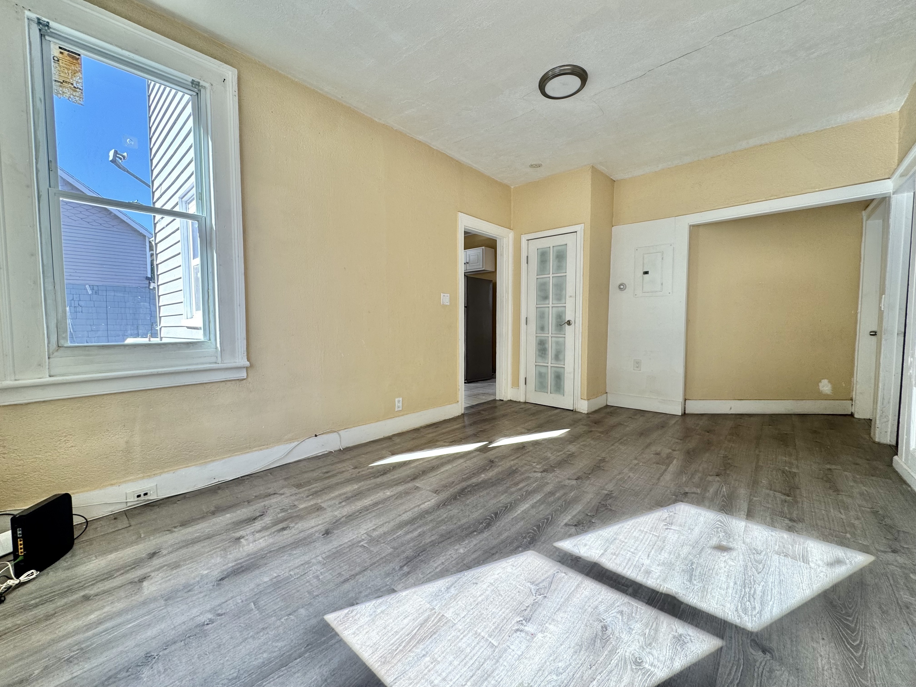 Undisclosed Address Bridgeport, CT 06608 - Photo 5 of 18 an empty room with wooden floor and windows