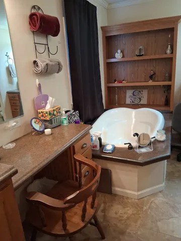a living room with furniture a fireplace and a chandelier