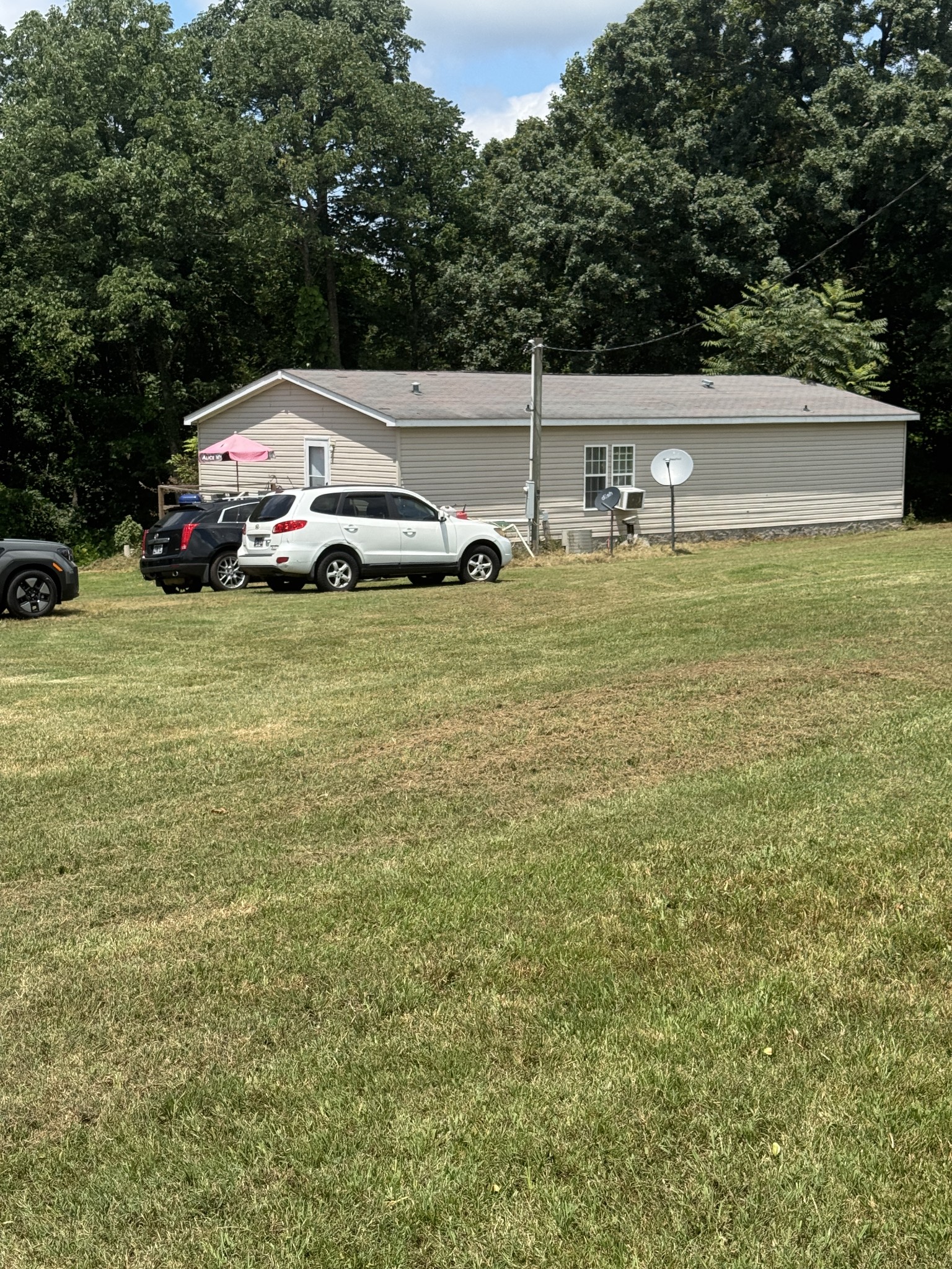 241 Greenfield Road Prospect, TN 38477 - Photo 32 of 32 a view of a car is parked in the yard with large trees