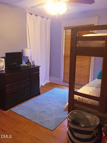 a room with a bed and a mirror