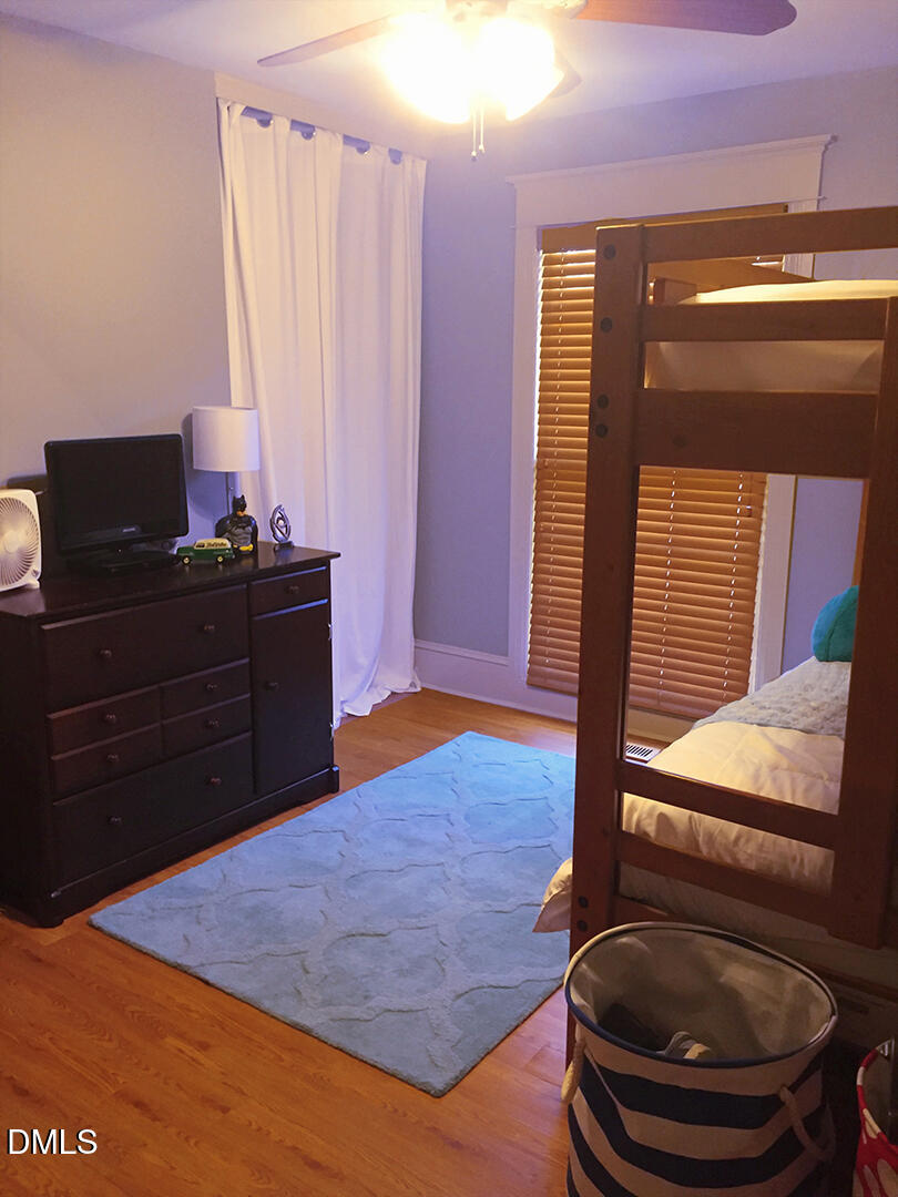 6404 Buffaloe Road Raleigh, NC 27616 - Photo 8 of 12 a room with a bed and a mirror