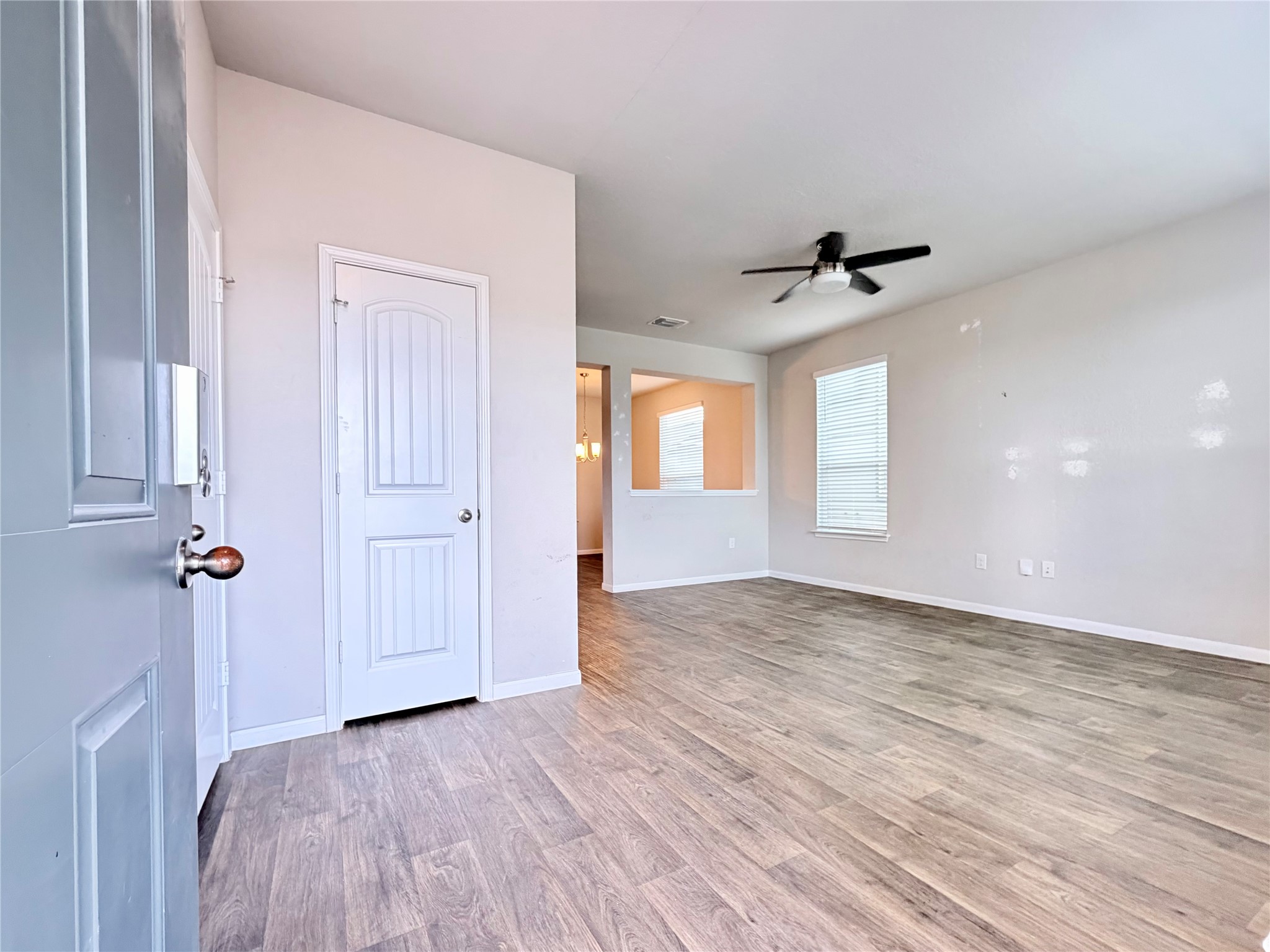 10502 Fulton Avenue Austin, TX 78754 - Photo 4 of 36 Natural light bathes this inviting living space, complete with durable flooring and a contemporary ceiling fan.