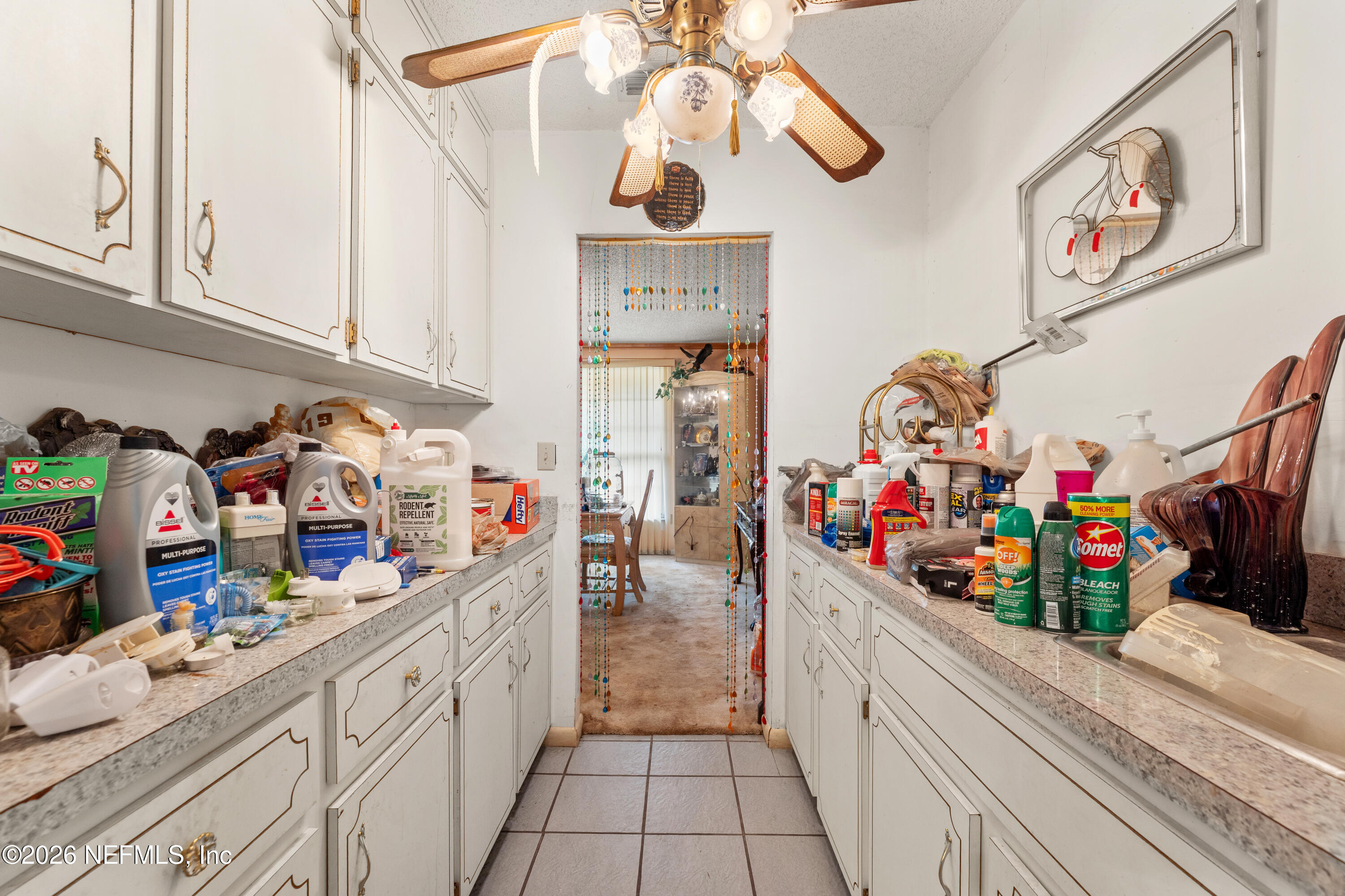 43001 Egger Place Callahan, FL 32011 - Photo 14 of 53 a kitchen with lots of clutter and cabinets