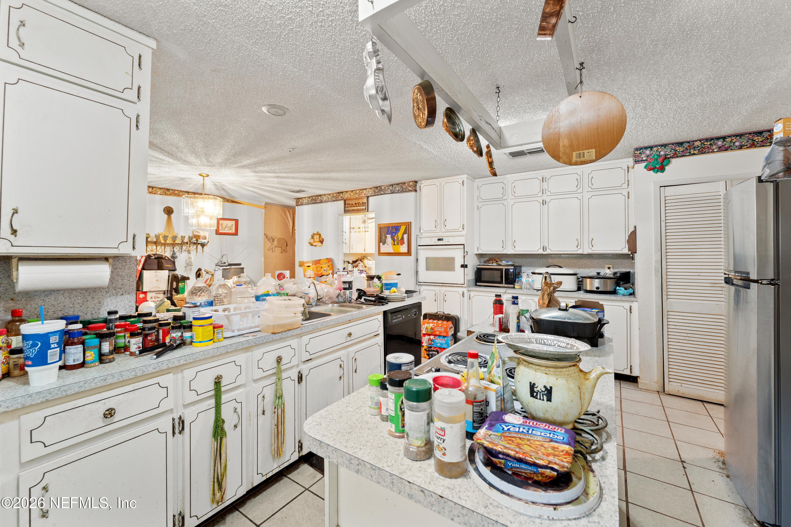 43001 Egger Place Callahan, FL 32011 - Photo 17 of 53 a kitchen filled with stainless steel appliances granite countertop a sink a stove a refrigerator and cabinets