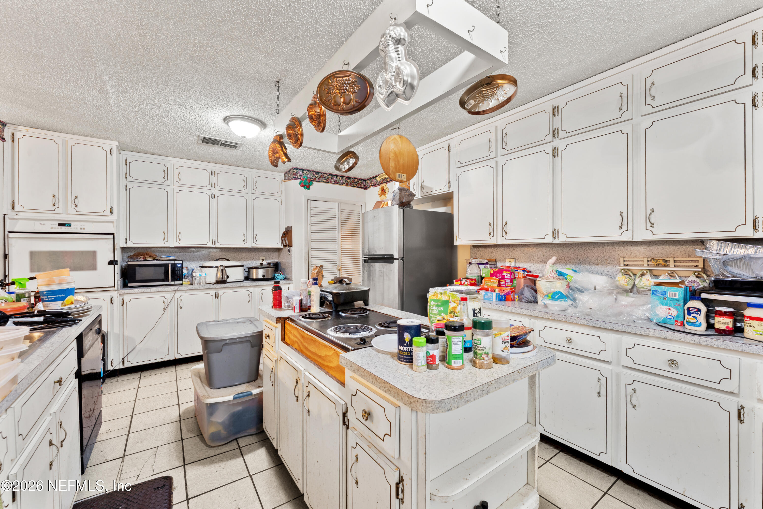 43001 Egger Place Callahan, FL 32011 - Photo 18 of 53 a kitchen filled with white cabinets and white appliances