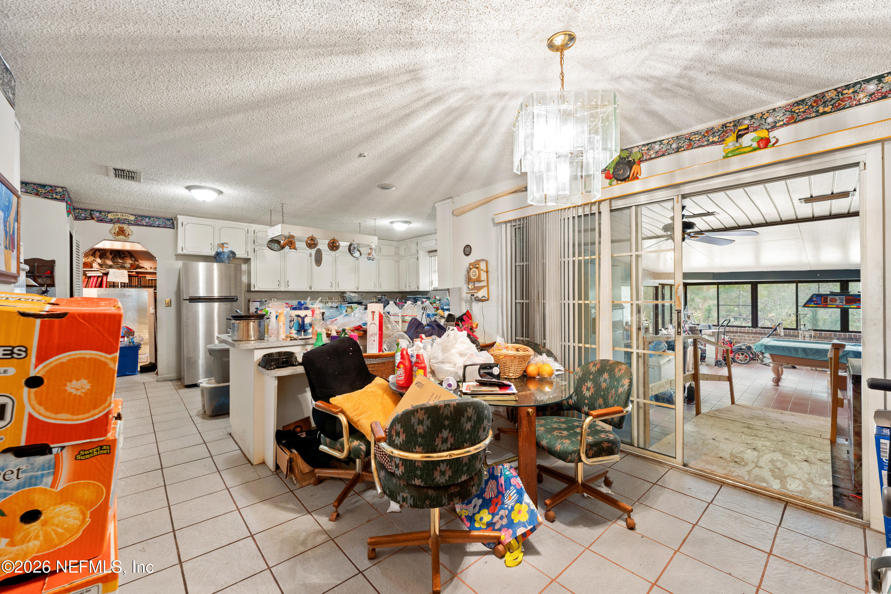 43001 Egger Place Callahan, FL 32011 - Photo 19 of 53 a room with lots of white furniture and a chandelier