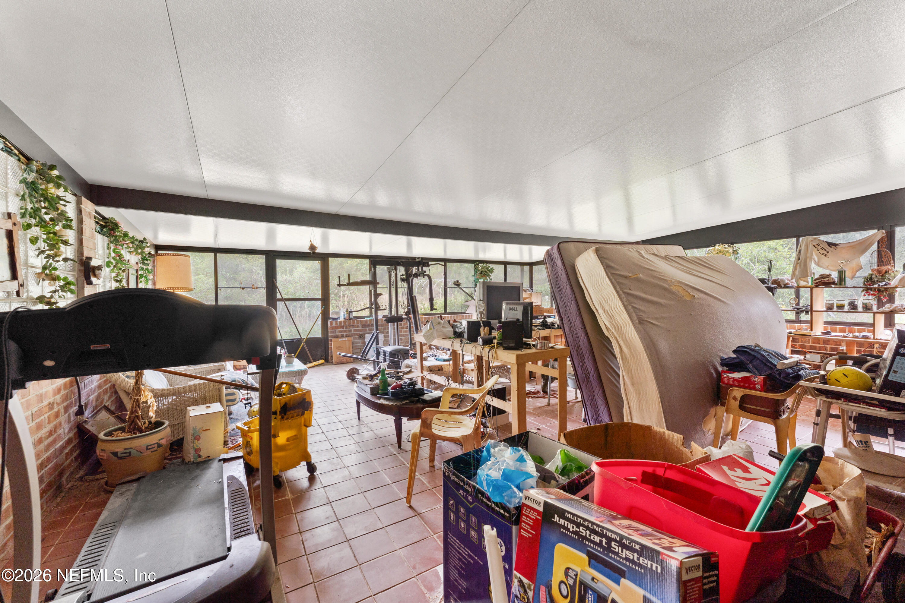 43001 Egger Place Callahan, FL 32011 - Photo 23 of 53 a living room with furniture and a floor to ceiling window