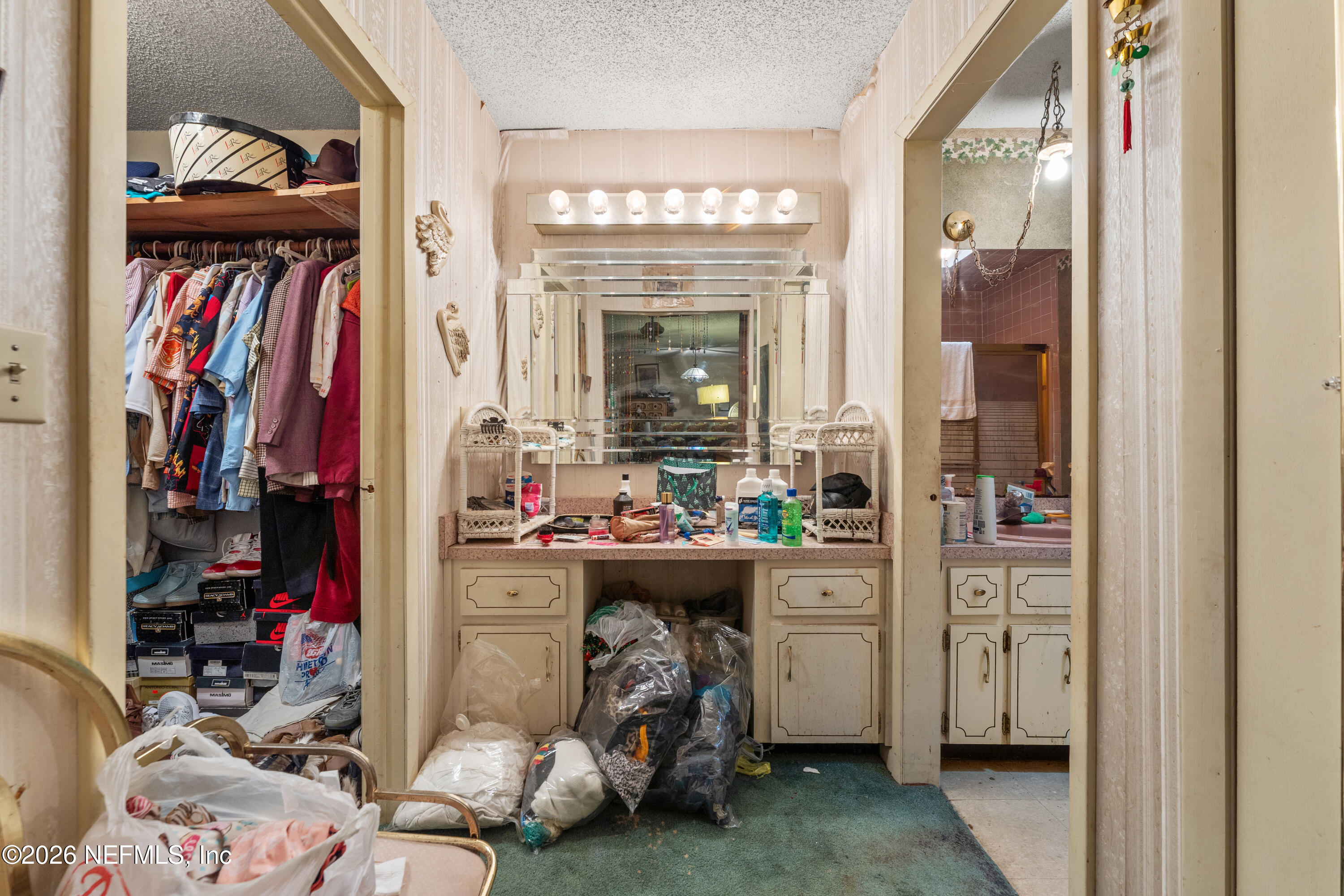 43001 Egger Place Callahan, FL 32011 - Photo 27 of 53 a view of walk in closet with clothes and shoes