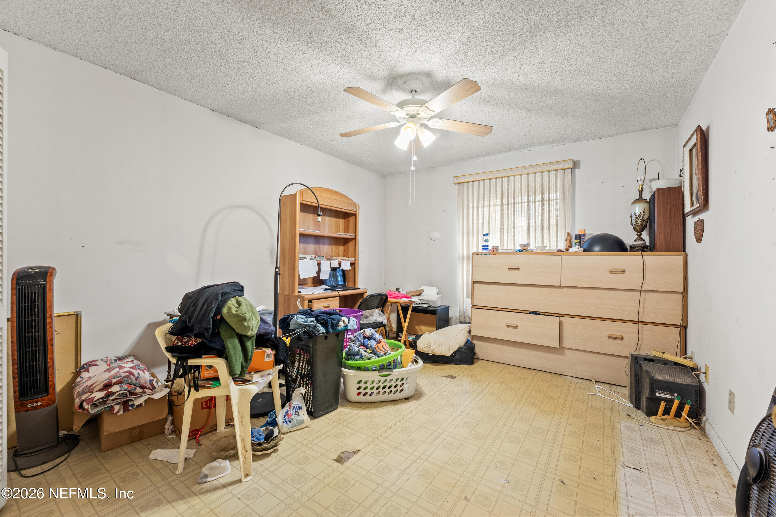 43001 Egger Place Callahan, FL 32011 - Photo 31 of 53 a bedroom with bed and a chandelier