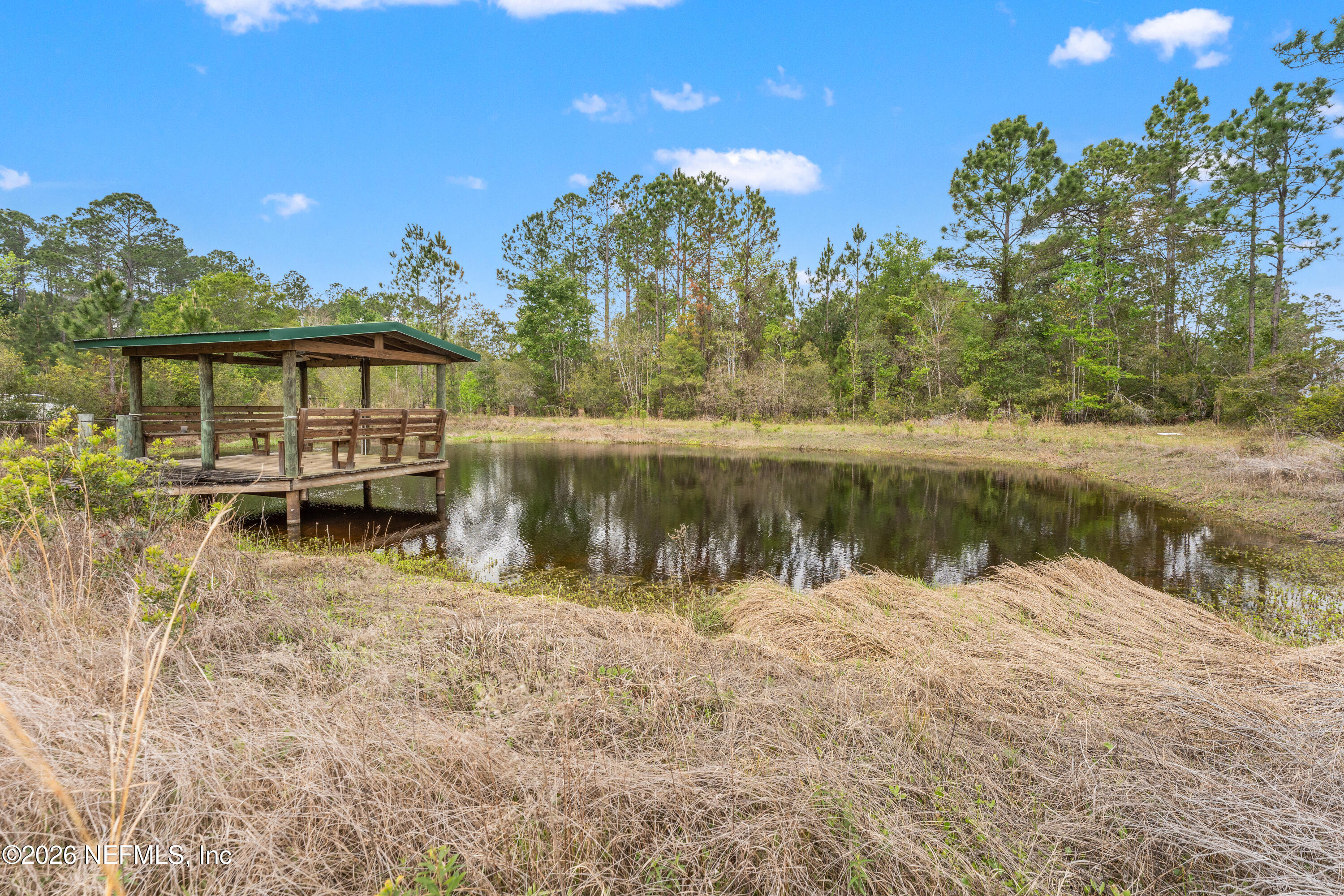 43001 Egger Place Callahan, FL 32011 - Photo 39 of 53 a view of a lake with a house in the background