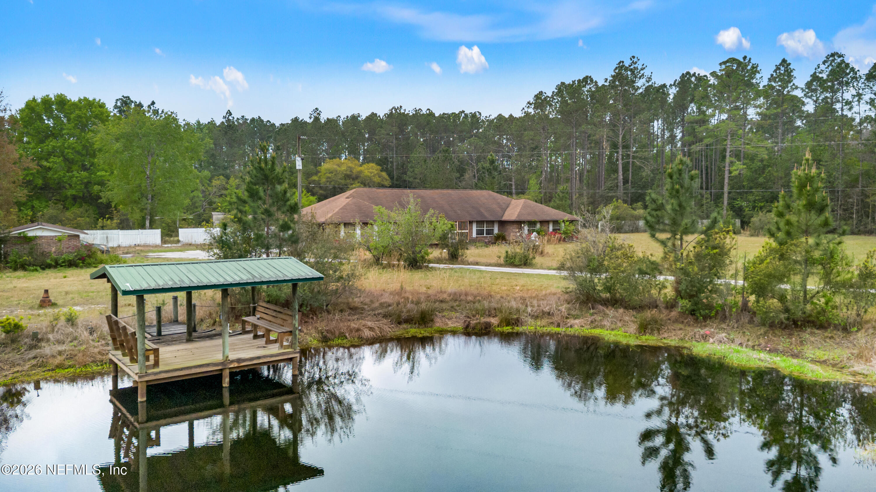 43001 Egger Place Callahan, FL 32011 - Photo 42 of 53 a view of a lake with a patio