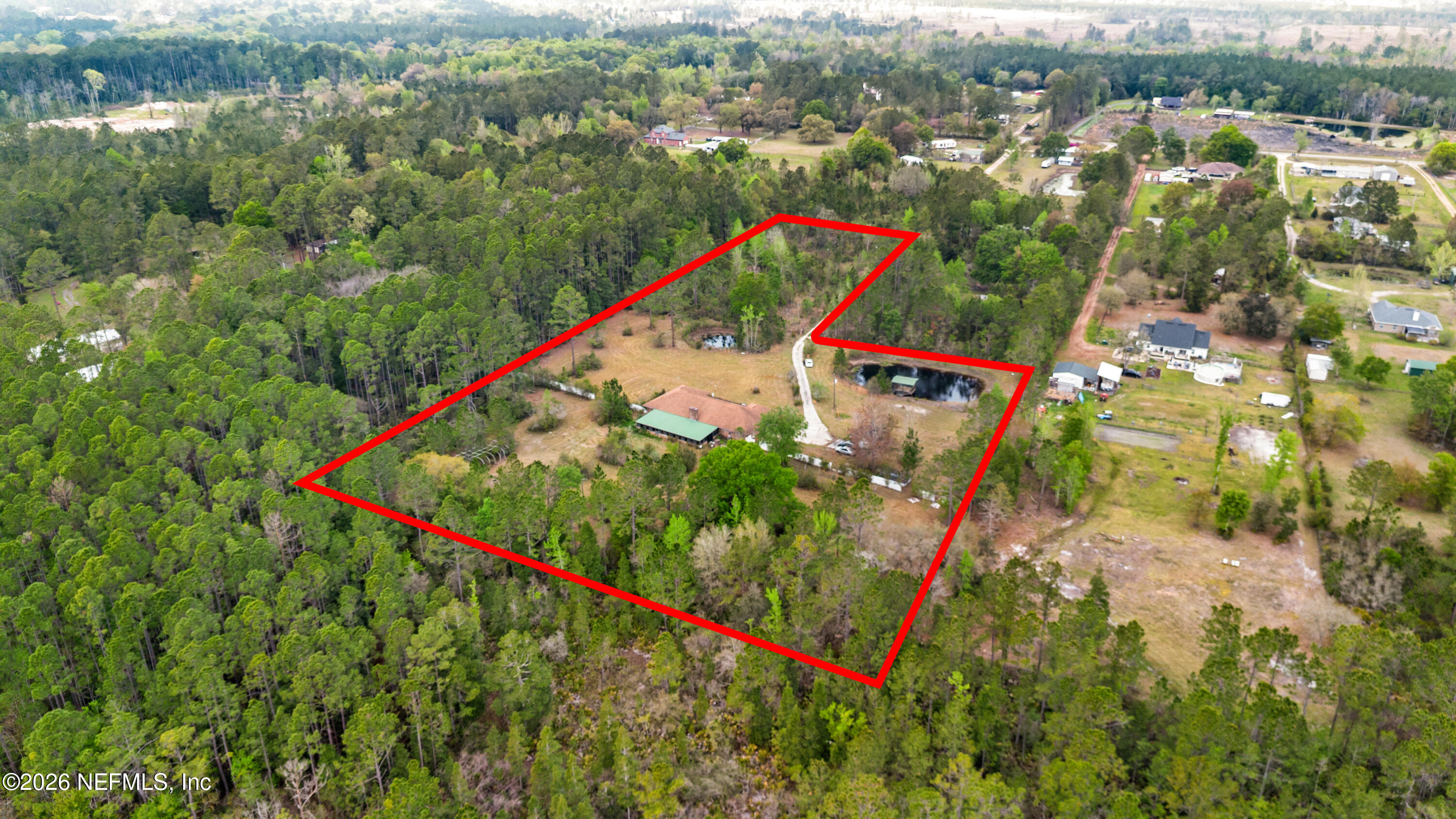 43001 Egger Place Callahan, FL 32011 - Photo 46 of 53 an aerial view of a houses with a lush green hillside