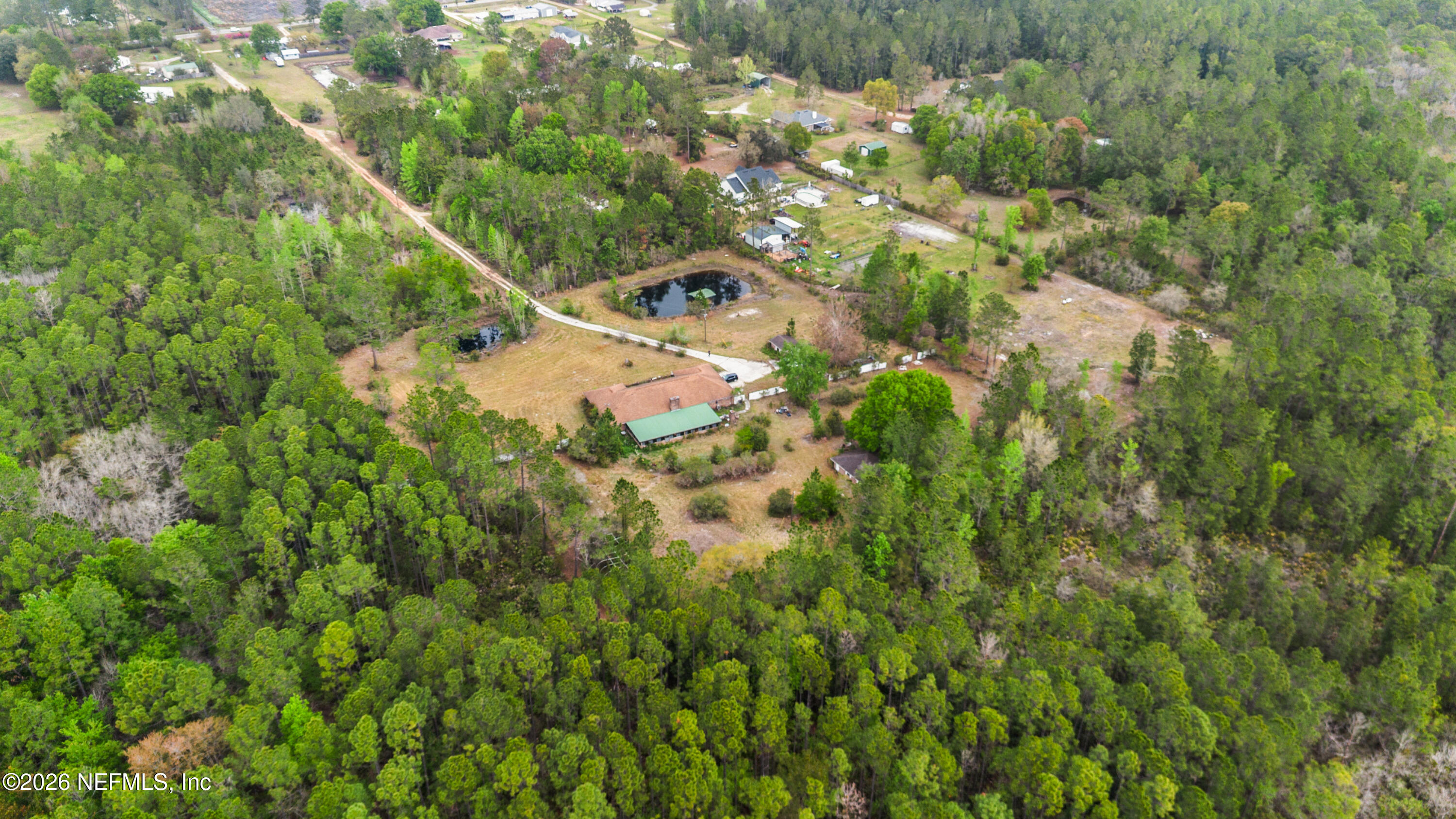 43001 Egger Place Callahan, FL 32011 - Photo 49 of 53 a view of a house with a lush green forest
