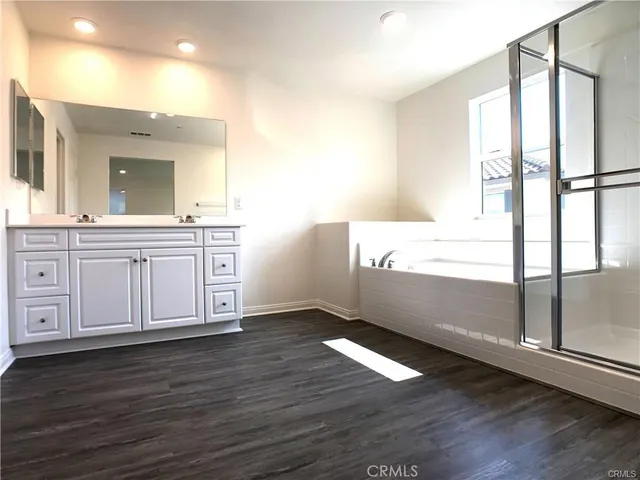 a view of a kitchen with wooden floor and electronic appliances