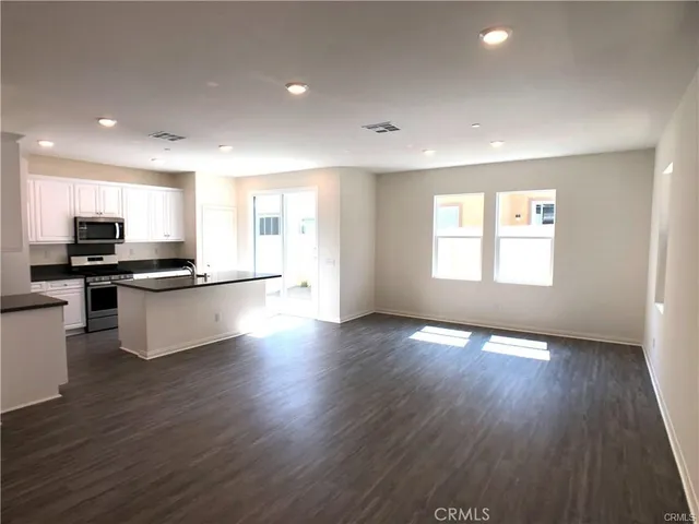 a view of kitchen with sink and wooden floor