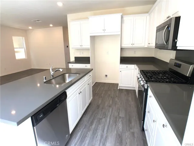 a kitchen with a sink stove and microwave