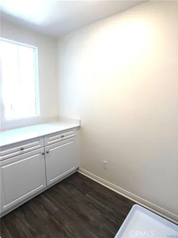 a view of storage and utility room with wooden floor