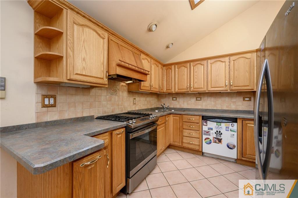 7 Florence Drive Sayreville, NJ 08859 - Photo 11 of 42 a kitchen with stainless steel appliances granite countertop a stove a sink and a refrigerator