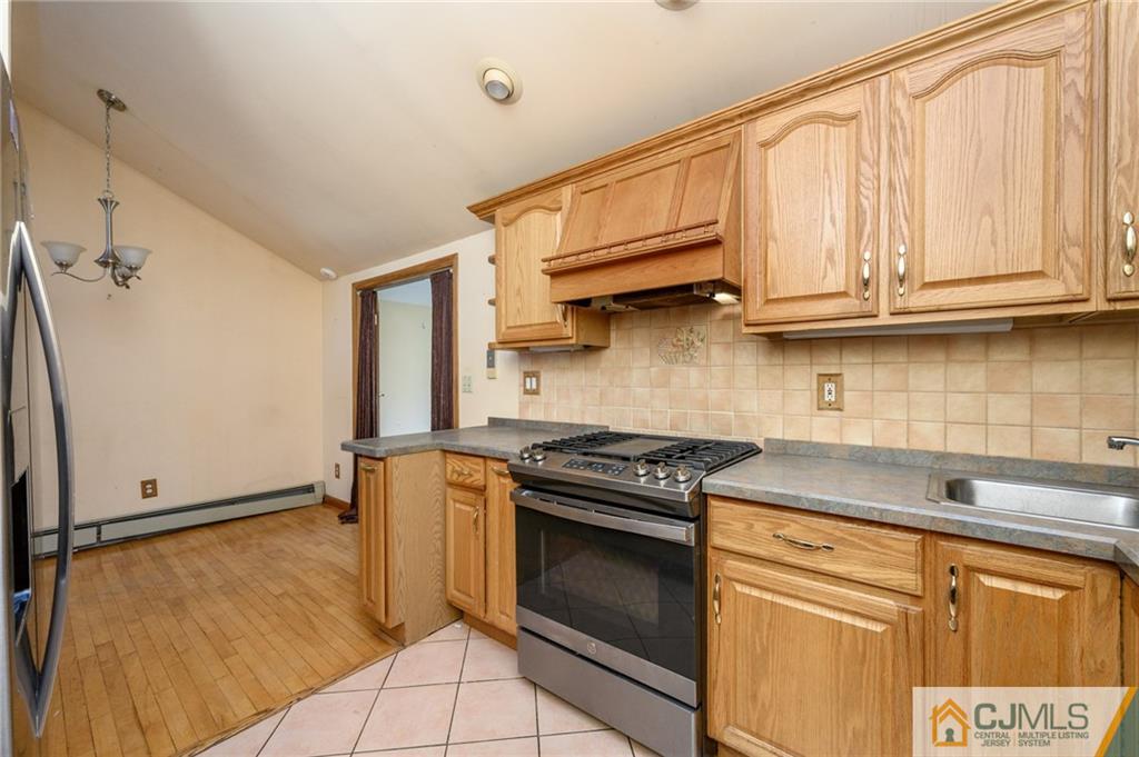 7 Florence Drive Sayreville, NJ 08859 - Photo 12 of 42 a kitchen with stainless steel appliances granite countertop a stove a sink and a granite counter tops