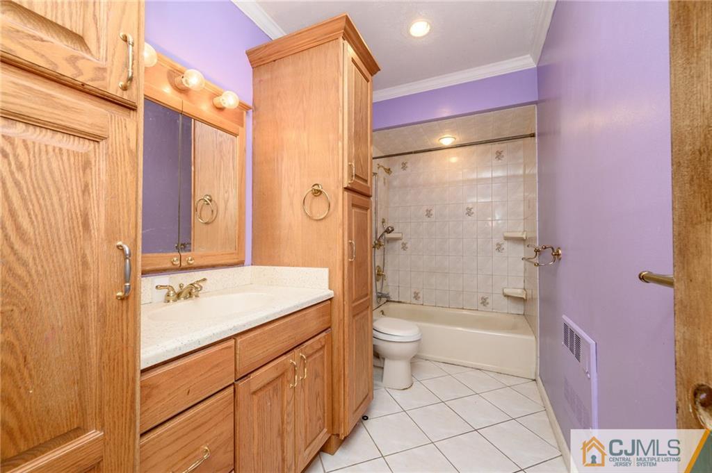 7 Florence Drive Sayreville, NJ 08859 - Photo 27 of 42 a bathroom with a sink a toilet and shower