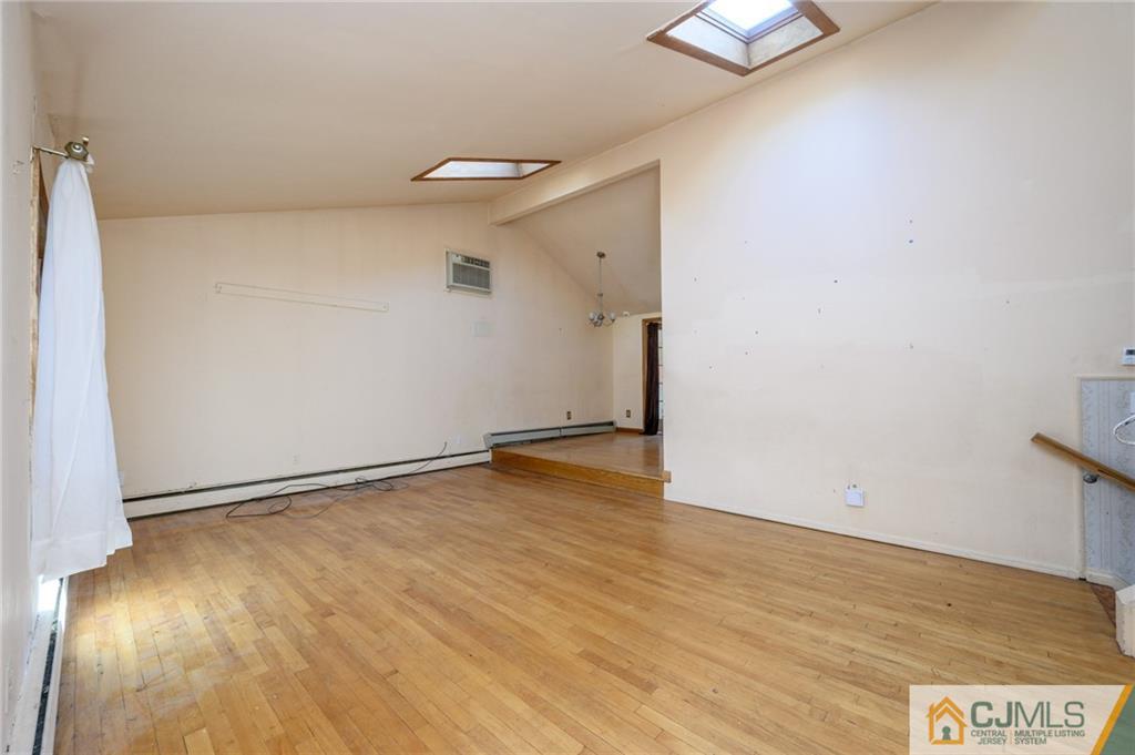 7 Florence Drive Sayreville, NJ 08859 - Photo 3 of 42 an empty room with wooden floor and windows