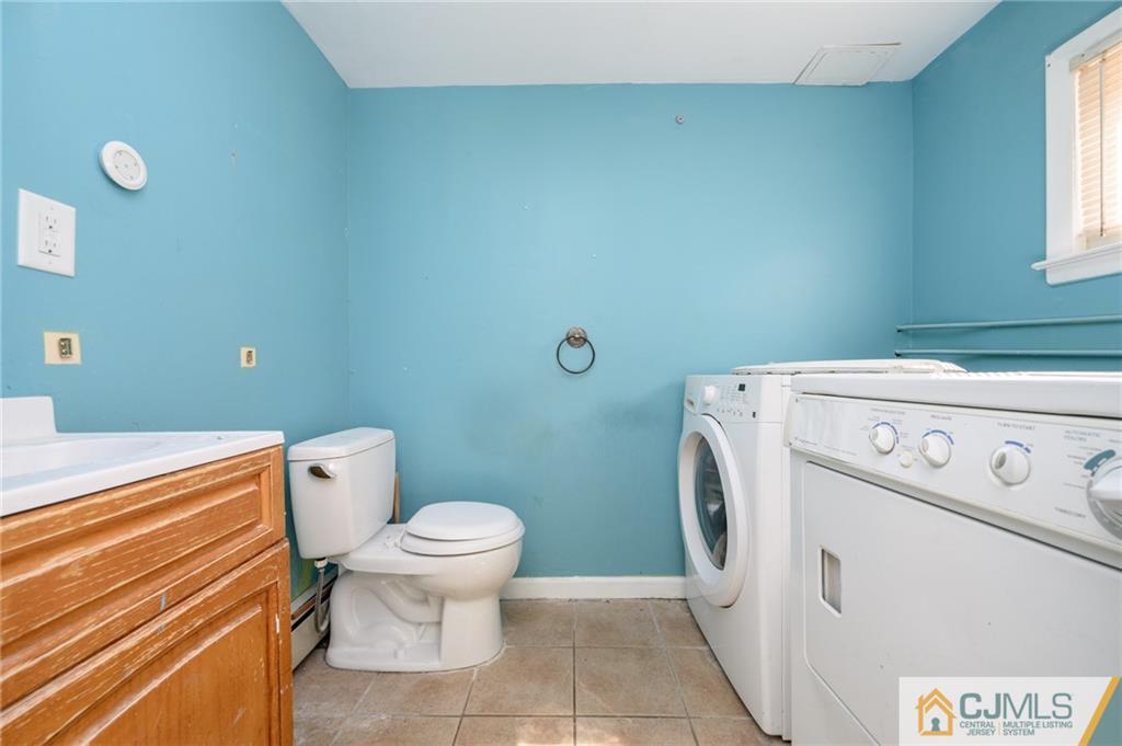 7 Florence Drive Sayreville, NJ 08859 - Photo 36 of 42 a bathroom with a toilet and a washing machine