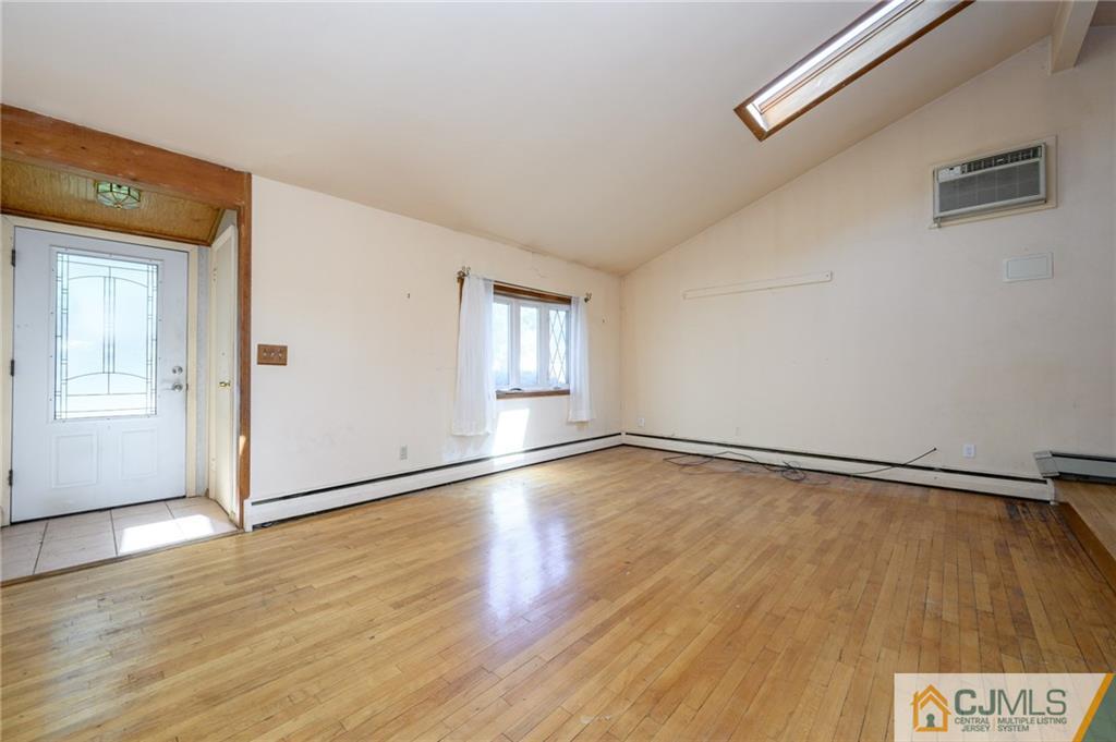 7 Florence Drive Sayreville, NJ 08859 - Photo 4 of 42 an empty room with wooden floor and windows