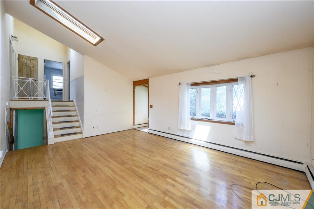 7 Florence Drive Sayreville, NJ 08859 - Photo 5 of 42 a view of an empty room with a window and wooden floor