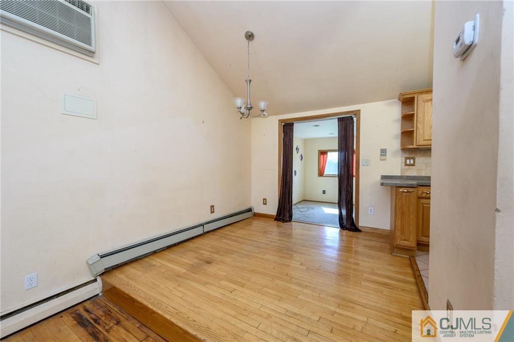 7 Florence Drive Sayreville, NJ 08859 - Photo 8 of 42 a view of a kitchen with wooden floor and a ceiling fan