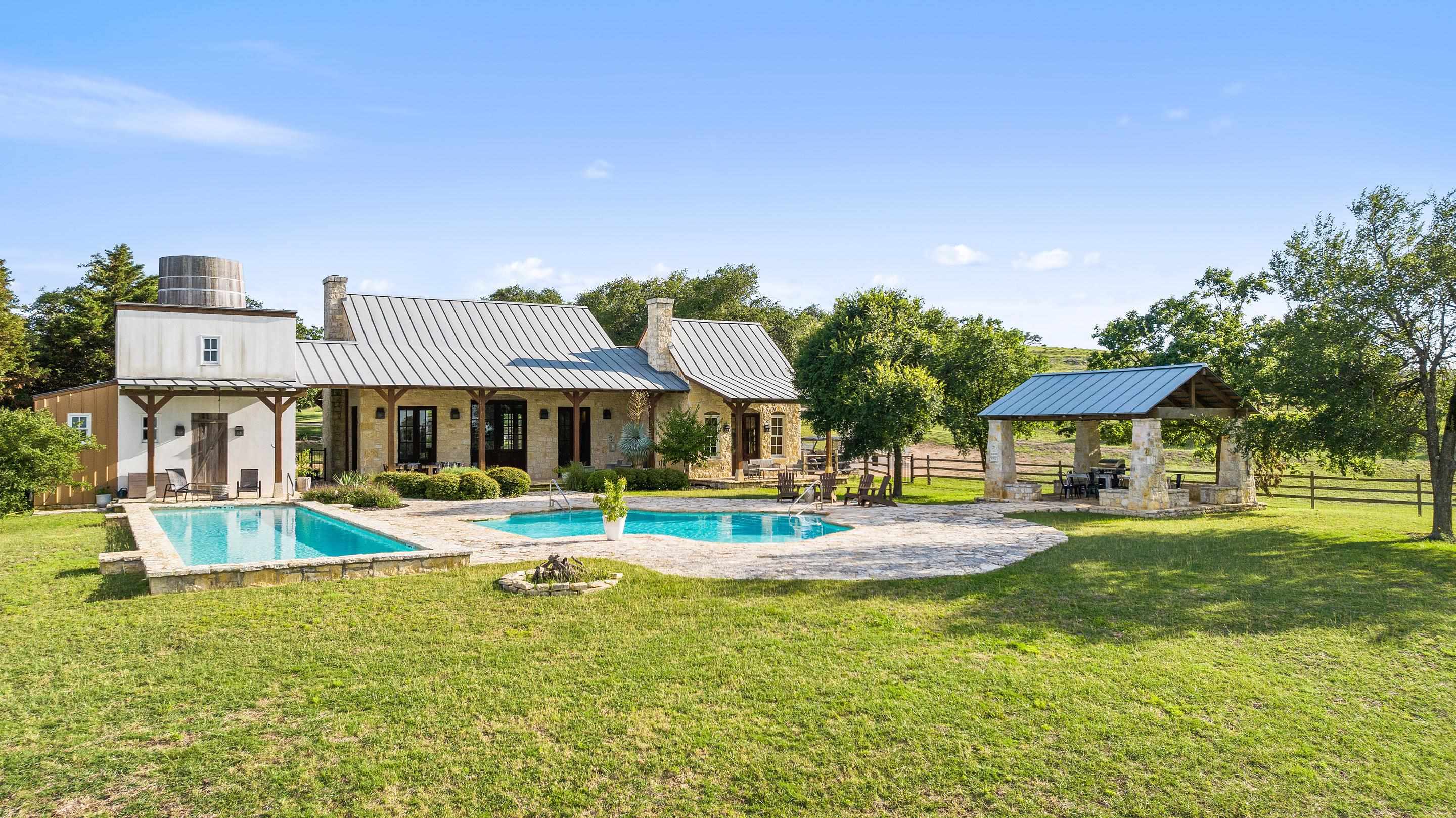 613 Cattle Creek Road Johnson City, TX 78636 - Photo 11 of 18 a view of a house with swimming pool and a yard