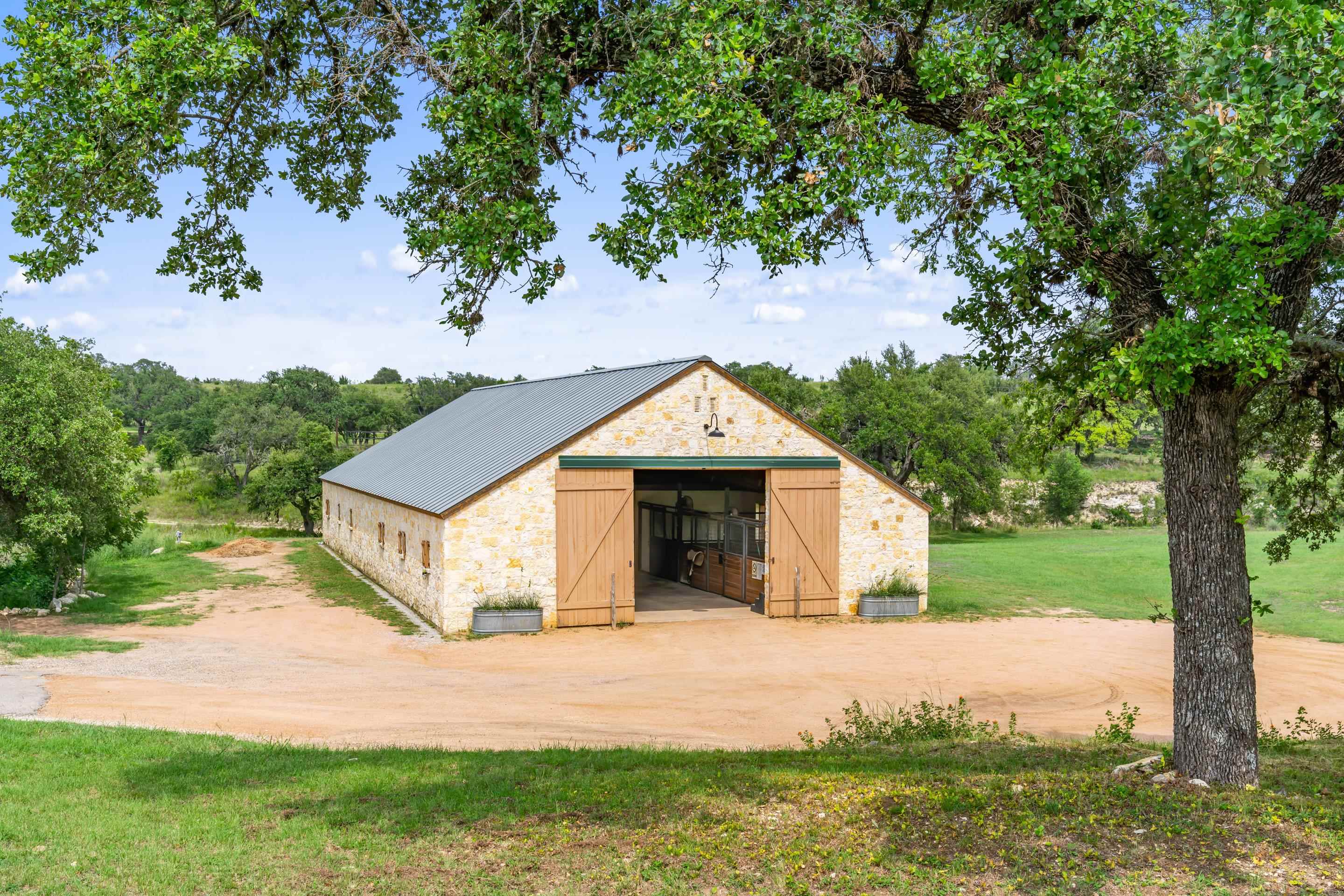 613 Cattle Creek Road Johnson City, TX 78636 - Photo 13 of 18 a front view of a house with garden