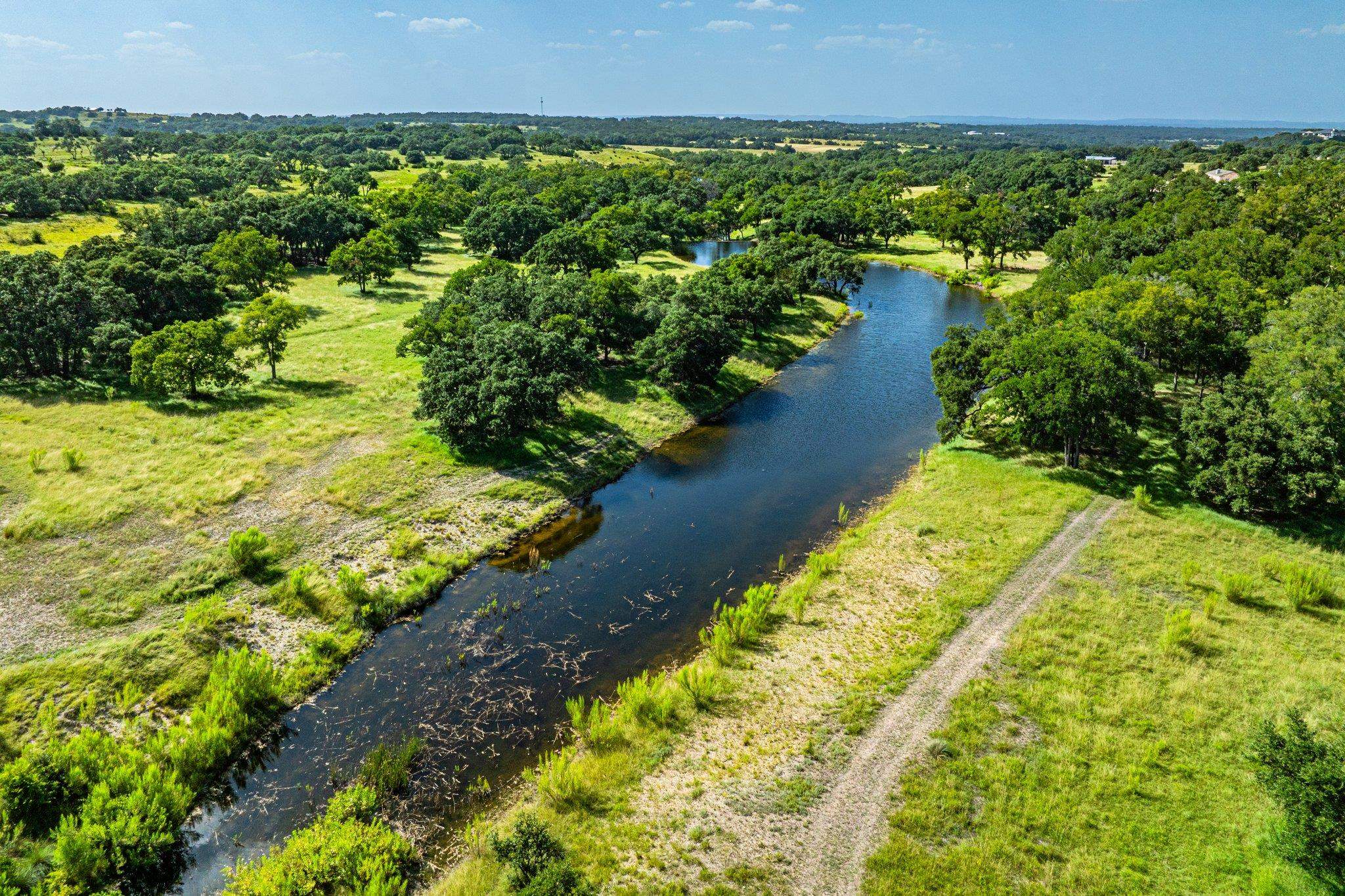 613 Cattle Creek Road Johnson City, TX 78636 - Photo 6 of 18 a view of a lake