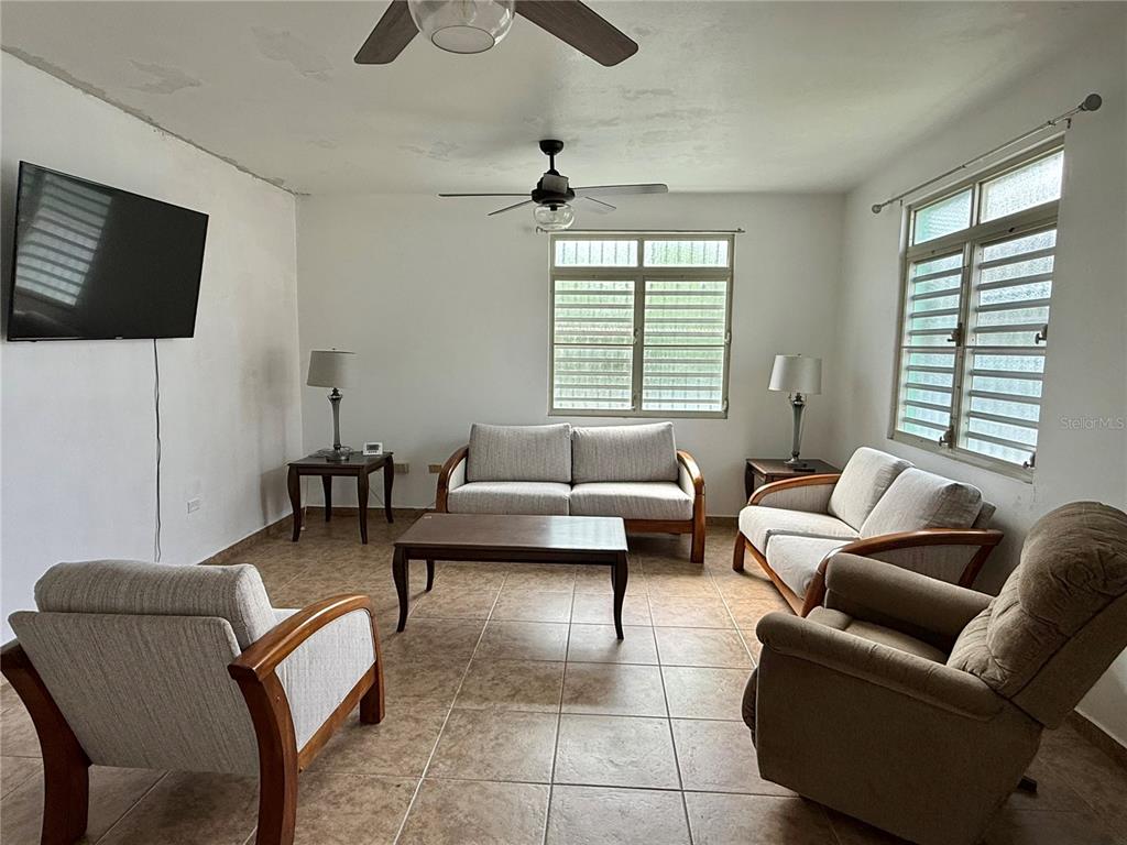 411 Bo Calvache Rincon, PR 00677 - Photo 3 of 14 a living room with furniture and a flat screen tv