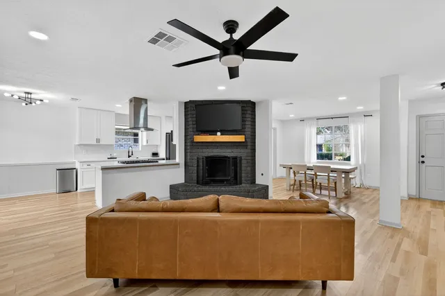 a living room with furniture a fireplace and a flat screen tv