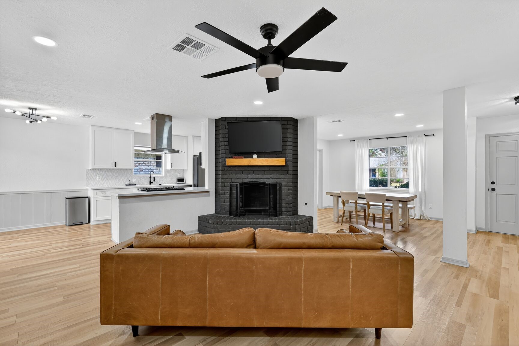 16122 Rill Lane Houston, TX 77062 - Photo 11 of 23 a living room with furniture a fireplace and a flat screen tv