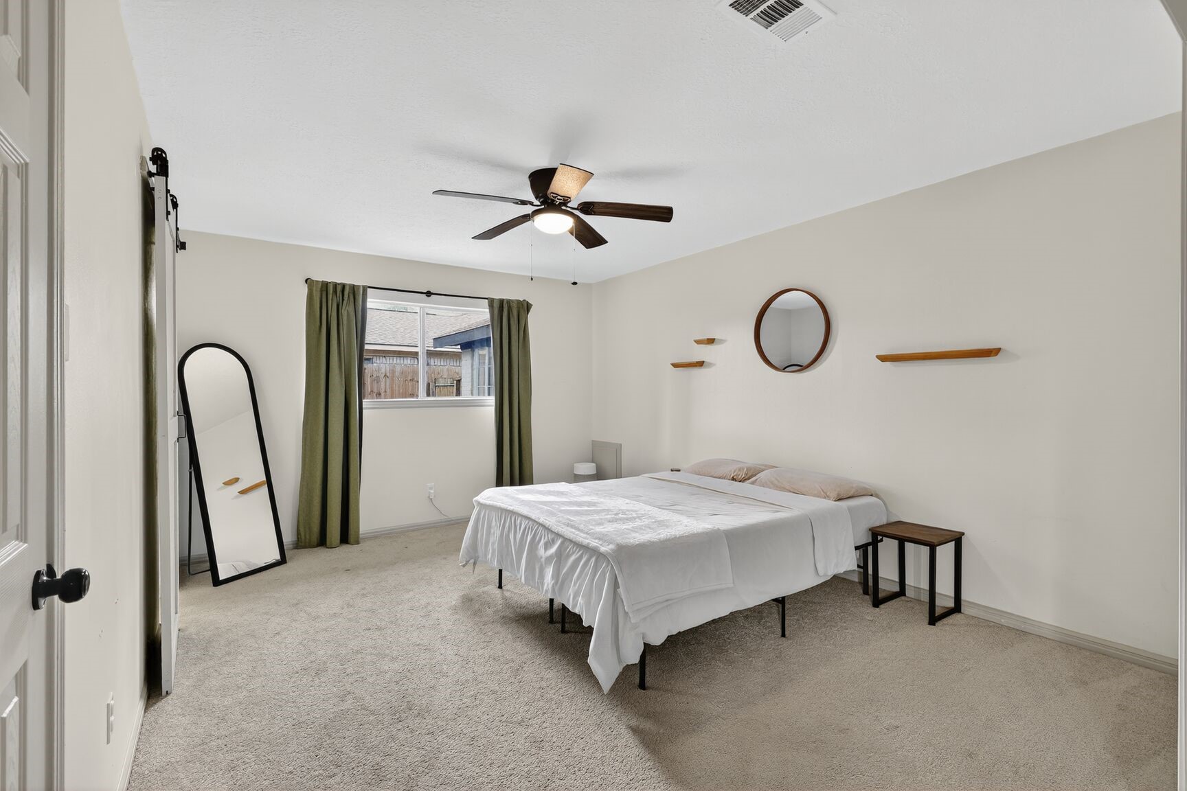 16122 Rill Lane Houston, TX 77062 - Photo 16 of 23 a bedroom with a bed and a chandelier