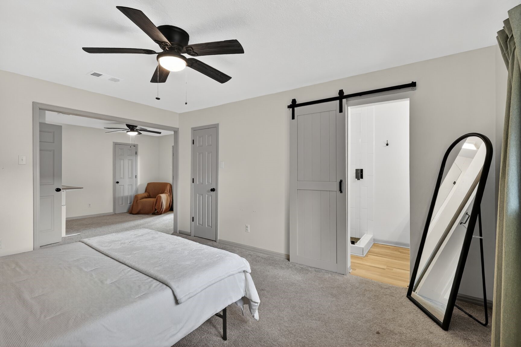 16122 Rill Lane Houston, TX 77062 - Photo 17 of 23 a bedroom with a bed and a chandelier