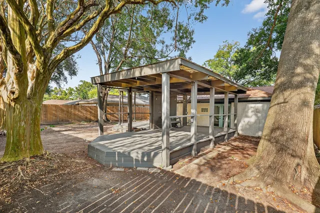 a view of a house with backyard porch and sitting area