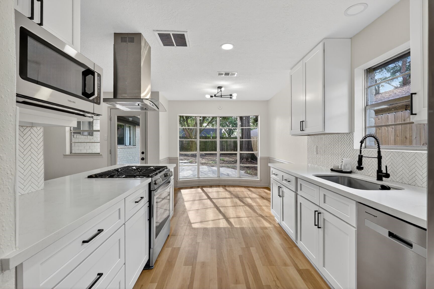 16122 Rill Lane Houston, TX 77062 - Photo 5 of 23 a kitchen with stainless steel appliances granite countertop a sink stove and cabinets