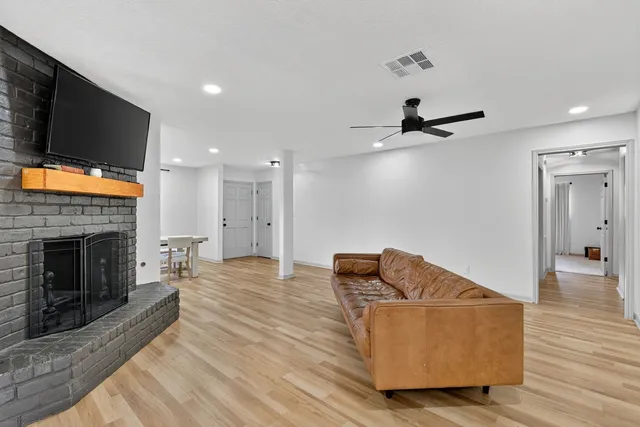 a living room with furniture and a fireplace